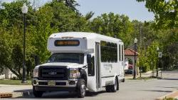 Shuttle driving into campus main entrance